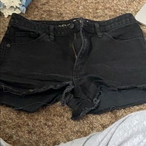 Black shorts with distressed details.